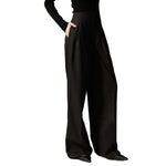 Petite woman wearing black high waisted wide leg pants
