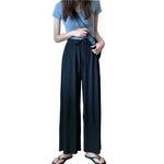 Women wearing black high waisted chiffon pants