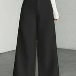 Women wearing black high waisted striped wide leg pants